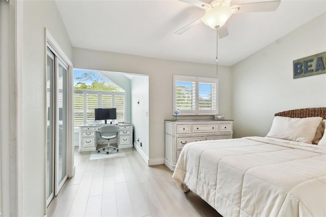 9812 Indian Key Trl Unit 84, Seminole, FL 33776 - bedroom with a desk, light wood-type flooring, baseboards, and ceiling fan