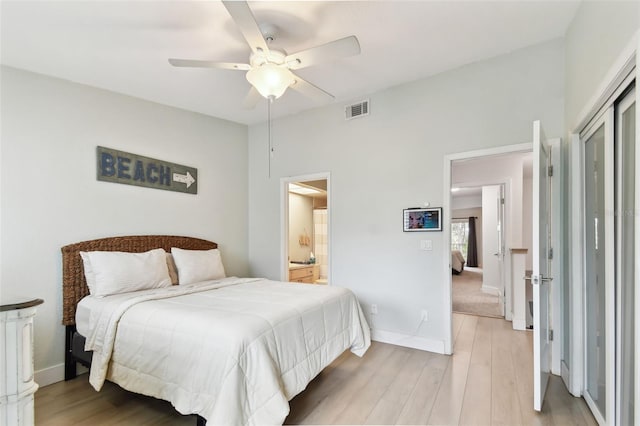 9812 Indian Key Trl Unit 84, Seminole, FL 33776 - bedroom with light wood-style floors, baseboards, a ceiling fan, and ensuite bath