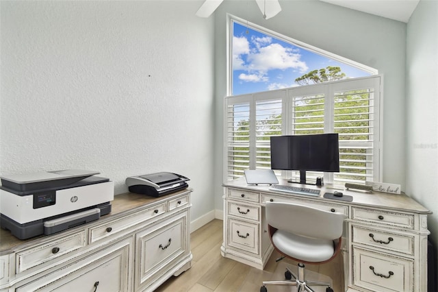 9812 Indian Key Trl Unit 84, Seminole, FL 33776 - home office featuring light wood finished floors, a ceiling fan, and baseboards