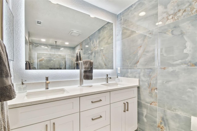 9812 Indian Key Trl Unit 84, Seminole, FL 33776 - full bath featuring double vanity, a stall shower, recessed lighting, and tile walls