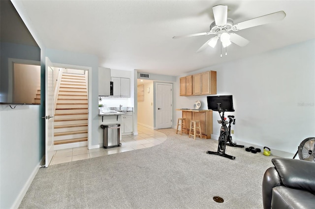 9812 Indian Key Trl Unit 84, Seminole, FL 33776 - workout area with ceiling fan, light tile patterned floors, light carpet, and baseboards