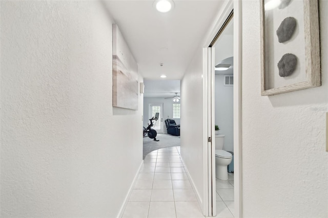9812 Indian Key Trl Unit 84, Seminole, FL 33776 - hall featuring light tile patterned floors, baseboards, a textured wall, and recessed lighting