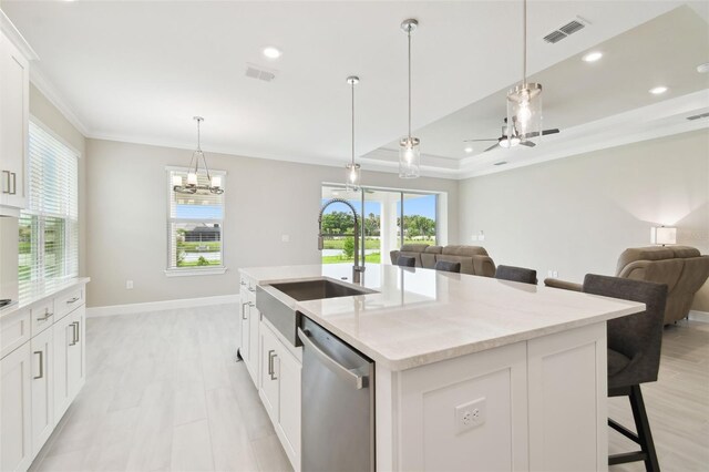 4709 Isonzo Way, Wesley Chapel, FL 33543 - kitchen featuring dishwasher, a sink, crown molding, open floor plan, and a breakfast bar area