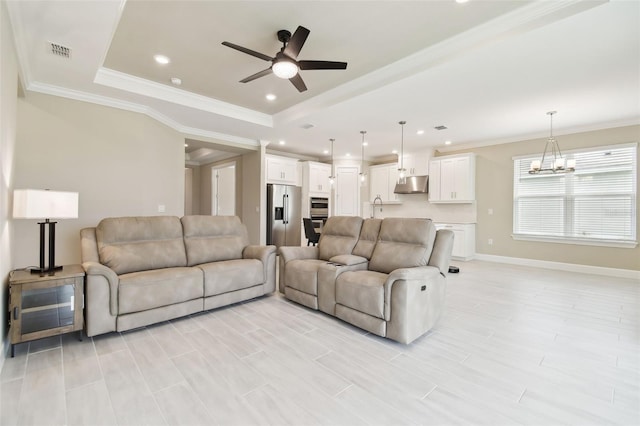 4709 Isonzo Way, Wesley Chapel, FL 33543 - living area with a tray ceiling, a ceiling fan, recessed lighting, a chandelier, and baseboards