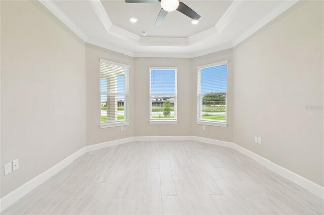 4709 Isonzo Way, Wesley Chapel, FL 33543 - spare room featuring ornamental molding, plenty of natural light, a raised ceiling, a ceiling fan, and baseboards