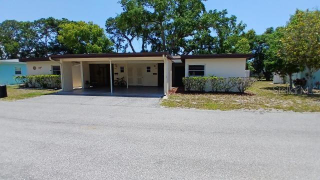 6263 Green View Cir Unit 107, Sarasota, FL 34231 - ranch-style house with an attached carport, asphalt driveway, and stucco siding