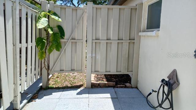6263 Green View Cir Unit 107, Sarasota, FL 34231 - view of patio / terrace with a gate and fence