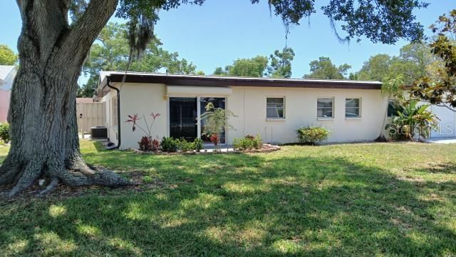 6263 Green View Cir Unit 107, Sarasota, FL 34231 - back of house featuring stucco siding, a yard, and cooling unit