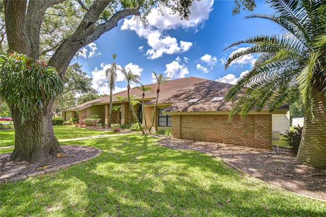 17917 Clear Lake Dr, Lutz, FL 33548 - view of front facade featuring brick siding and a front yard