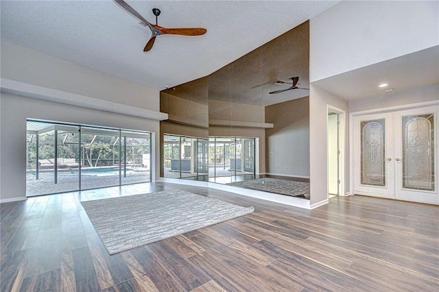 17917 Clear Lake Dr, Lutz, FL 33548 - unfurnished living room with ceiling fan, a high ceiling, wood finished floors, and baseboards