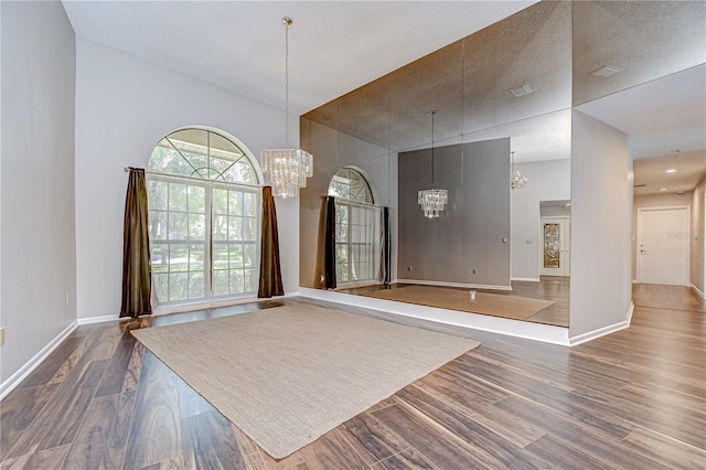 17917 Clear Lake Dr, Lutz, FL 33548 - unfurnished room with a chandelier, a high ceiling, dark wood-type flooring, and baseboards