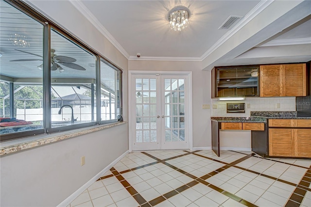 17917 Clear Lake Dr, Lutz, FL 33548 - kitchen with tasteful backsplash, brown cabinetry, baseboards, french doors, and a ceiling fan