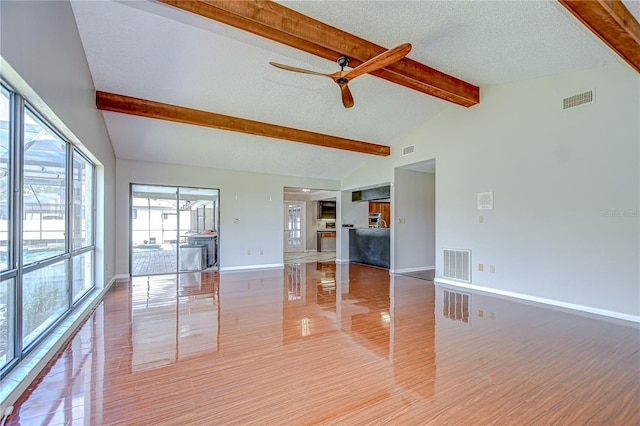 17917 Clear Lake Dr, Lutz, FL 33548 - unfurnished living room with ceiling fan, baseboards, a textured ceiling, and light wood-type flooring
