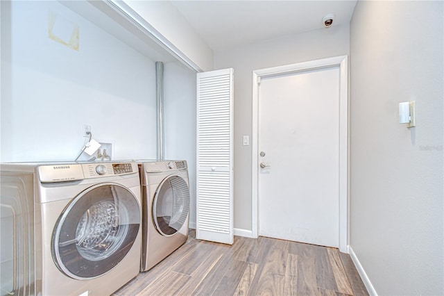 17917 Clear Lake Dr, Lutz, FL 33548 - washroom with washing machine and dryer, wood finished floors, and baseboards
