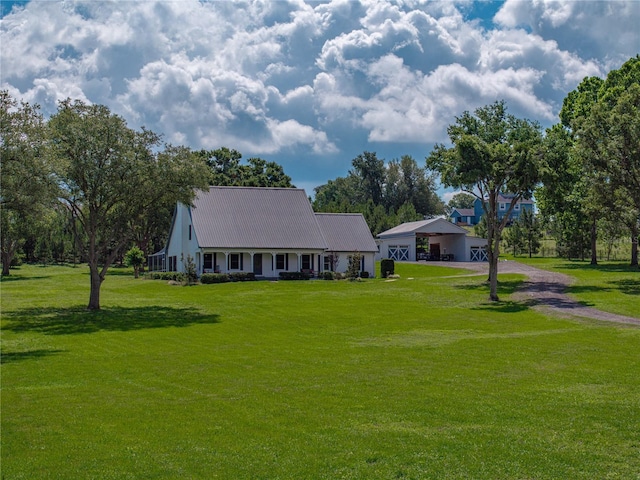 16326 Kalli Way, Dade City, FL 33523 - view of front of house featuring dirt driveway, a front yard, and metal roof