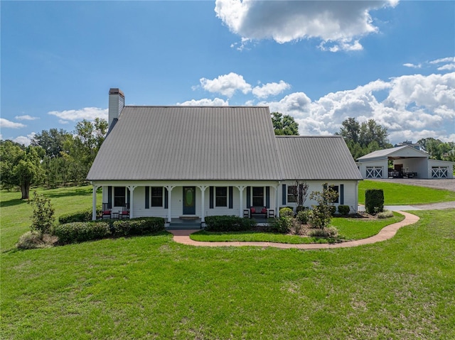 16326 Kalli Way, Dade City, FL 33523 - view of front of house with a chimney, covered porch, metal roof, a front lawn, and asphalt driveway