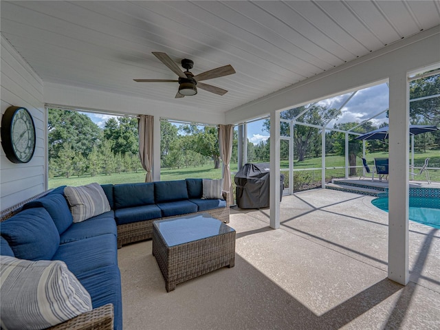 16326 Kalli Way, Dade City, FL 33523 - sunroom featuring a ceiling fan, outdoor lounge area, and view of wooded area