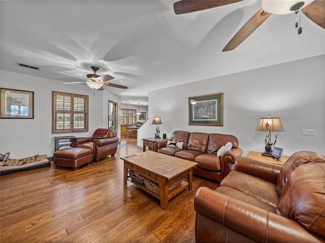16326 Kalli Way, Dade City, FL 33523 - living room with ceiling fan, wood finished floors, and a textured ceiling