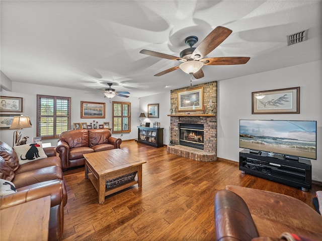 16326 Kalli Way, Dade City, FL 33523 - living room featuring a ceiling fan, a brick fireplace, and hardwood / wood-style flooring