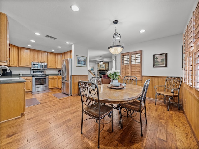 16326 Kalli Way, Dade City, FL 33523 - dining space with wainscoting, wood walls, light wood finished floors, recessed lighting, and healthy amount of natural light