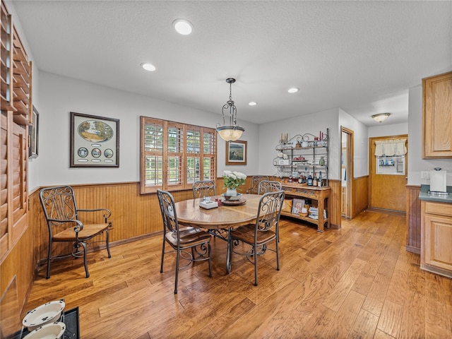 16326 Kalli Way, Dade City, FL 33523 - dining room with a wainscoted wall, light wood-style flooring, wood walls, and recessed lighting