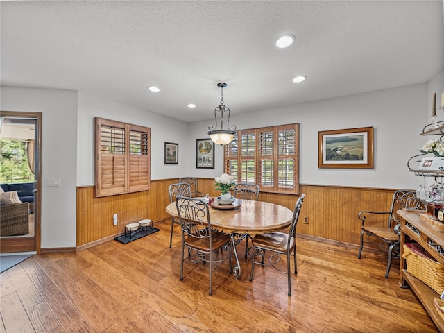 16326 Kalli Way, Dade City, FL 33523 - dining area with a wainscoted wall, wood walls, light wood finished floors, a textured ceiling, and recessed lighting
