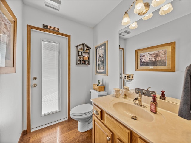 16326 Kalli Way, Dade City, FL 33523 - bathroom with vanity, toilet, and wood finished floors