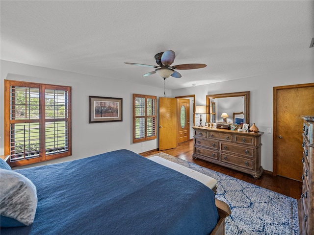 16326 Kalli Way, Dade City, FL 33523 - bedroom featuring wood finished floors, multiple windows, baseboards, and ceiling fan