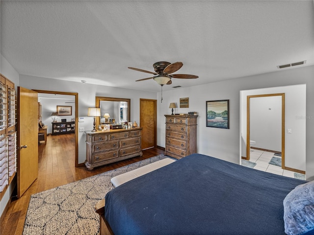 16326 Kalli Way, Dade City, FL 33523 - bedroom featuring hardwood / wood-style floors, a textured ceiling, and ceiling fan