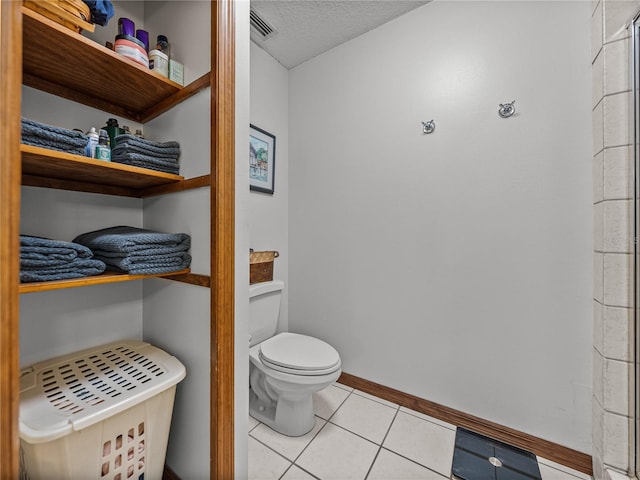 16326 Kalli Way, Dade City, FL 33523 - bathroom with toilet, tile patterned floors, baseboards, and a textured ceiling