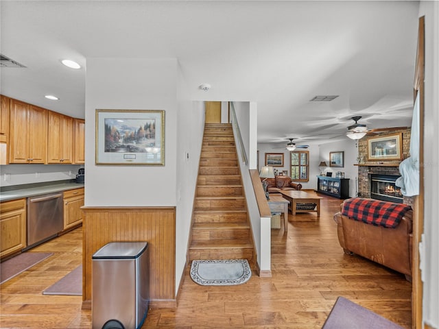 16326 Kalli Way, Dade City, FL 33523 - stairs featuring ceiling fan, a brick fireplace, wood finished floors, and recessed lighting