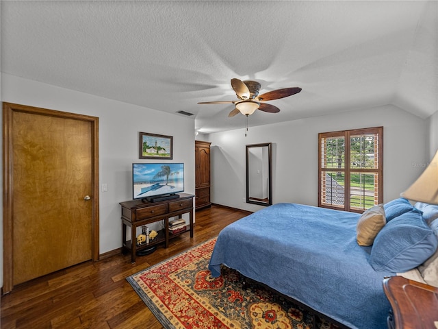 16326 Kalli Way, Dade City, FL 33523 - bedroom with dark wood-style floors, ceiling fan, a textured ceiling, baseboards, and vaulted ceiling