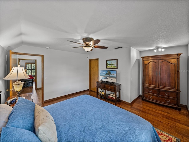 16326 Kalli Way, Dade City, FL 33523 - bedroom with dark wood-style floors, a ceiling fan, baseboards, and lofted ceiling