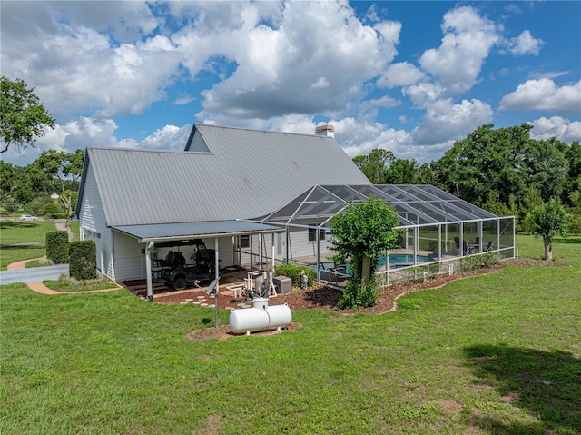 16326 Kalli Way, Dade City, FL 33523 - rear view of house with a yard, an outdoor pool, metal roof, and a chimney
