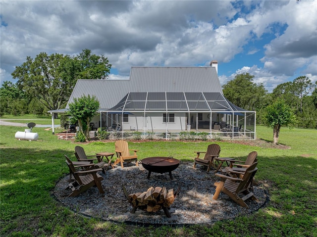 16326 Kalli Way, Dade City, FL 33523 - back of property featuring a fire pit, a yard, a lanai, and a chimney
