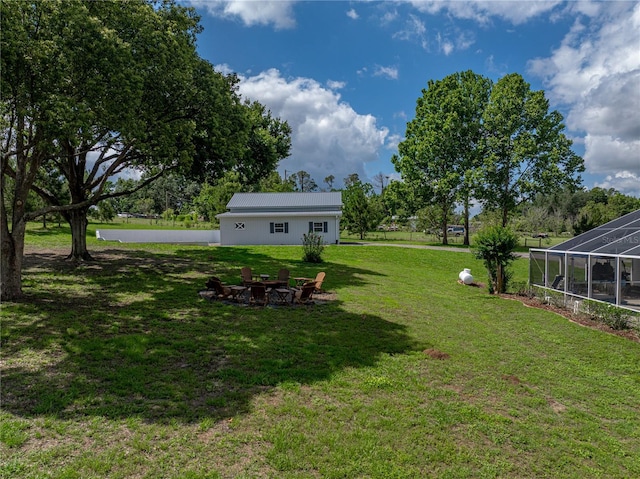 16326 Kalli Way, Dade City, FL 33523 - view of green lawn with a fire pit and a lanai