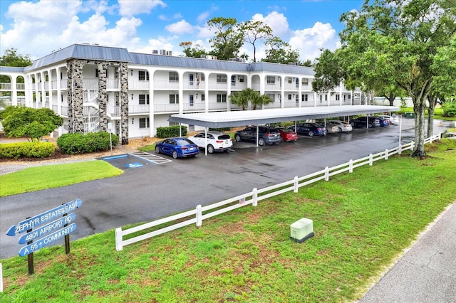 4801 Airport Rd Unit 210, Zephyrhills, FL 33542 - view of property featuring covered and uncovered parking