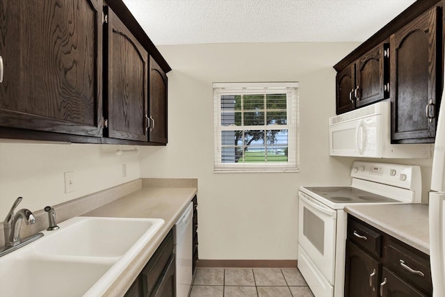 4801 Airport Rd Unit 210, Zephyrhills, FL 33542 - kitchen with white appliances, a sink, dark brown cabinetry, light countertops, and a textured ceiling