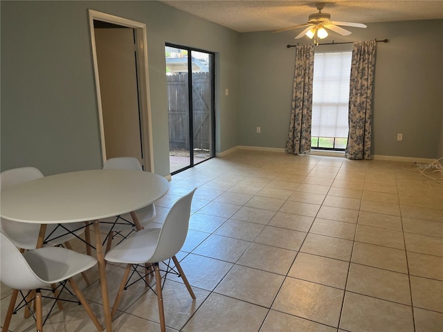 4008 Ashford Green Pl Unit F101, Tampa, FL 33613 - dining area with plenty of natural light, ceiling fan, a textured ceiling, light tile patterned floors, and baseboards