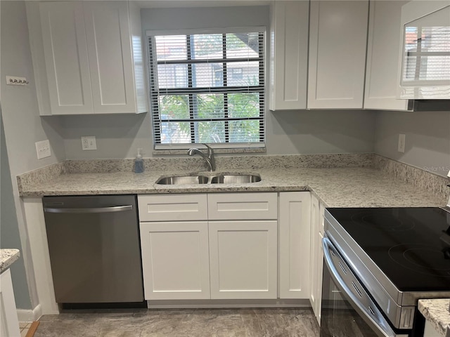 4008 Ashford Green Pl Unit F101, Tampa, FL 33613 - kitchen with dishwasher, a sink, electric range oven, and white cabinets
