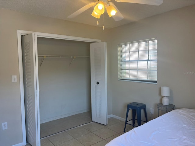 4008 Ashford Green Pl Unit F101, Tampa, FL 33613 - bedroom featuring a closet, tile patterned floors, a ceiling fan, and baseboards