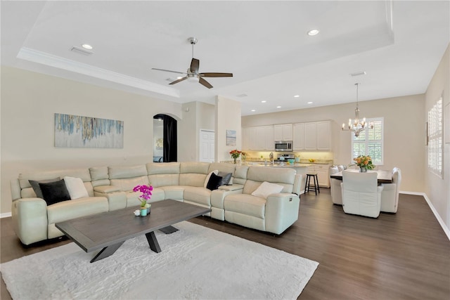 13872 Siena Loop, Lakewood Ranch, FL 34202 - living room with a raised ceiling, dark wood-type flooring, arched walkways, a chandelier, and recessed lighting