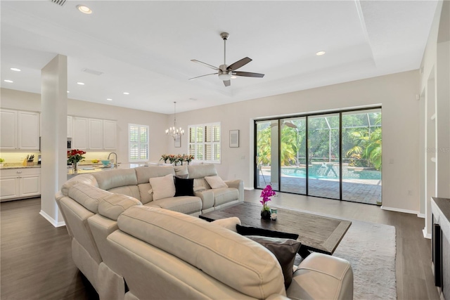13872 Siena Loop, Lakewood Ranch, FL 34202 - living room with ceiling fan, dark wood-type flooring, a chandelier, recessed lighting, and baseboards