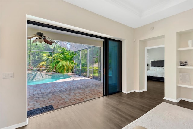13872 Siena Loop, Lakewood Ranch, FL 34202 - doorway to outside with a sunroom, wood finished floors, a ceiling fan, built in shelves, and crown molding