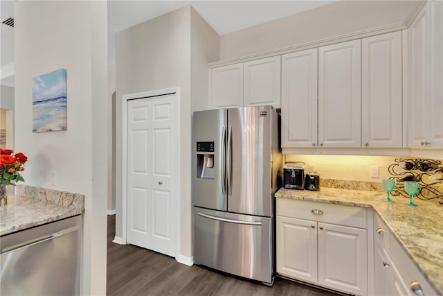 13872 Siena Loop, Lakewood Ranch, FL 34202 - kitchen with appliances with stainless steel finishes, dark wood finished floors, white cabinets, light stone counters, and tasteful backsplash