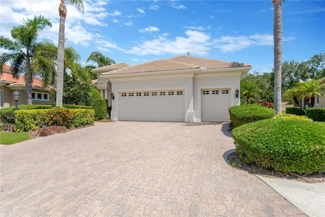 13872 Siena Loop, Lakewood Ranch, FL 34202 - view of front of property featuring decorative driveway, an attached garage, a tile roof, and stucco siding