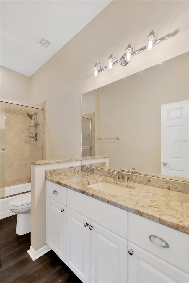 13872 Siena Loop, Lakewood Ranch, FL 34202 - full bathroom featuring toilet, vanity, wood finished floors, and shower / tub combination
