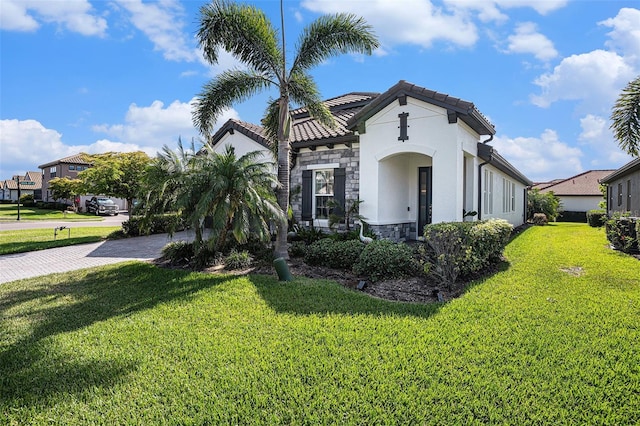 2515 63rd Ter E, Ellenton, FL 34222 - view of front of property with stone siding, a front yard, stucco siding, and a tiled roof