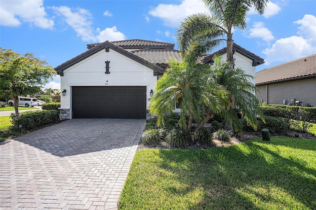 2515 63rd Ter E, Ellenton, FL 34222 - view of front of property with decorative driveway, a front lawn, a garage, stucco siding, and a tile roof