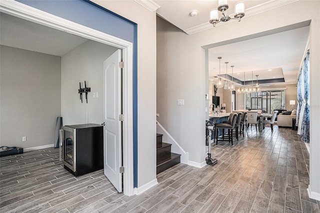 2515 63rd Ter E, Ellenton, FL 34222 - hall featuring a chandelier, wood finished floors, baseboards, and ornamental molding